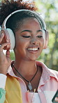 Phone, girl and dancing with headphones at park for music playlist, online radio and subscription. Relax, person and smile with mobile app outdoor for audio album, weekend break and listening to song