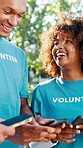 Volunteer team, people and phone at park with laughing, global connection or funny NGO website. Non profit group, smartphone and happy with online coordination, community service chat or notification