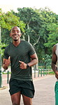 Happy, running and men in park for fitness, marathon training and cardio workout outdoors. Runner, sports and friends talking for practice, endurance and challenge for wellness, exercise and health