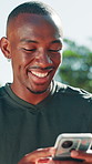 Happy, black man and fitness with phone in nature for online app, social media or chatting. Active, male person or user with smile on mobile smartphone for texting, communication or sports news