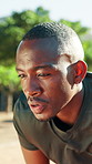 Park, fitness and tired black man breathing for workout recovery, cardio endurance and wind. African person, fatigue and runner outdoor for rest, wellness and training challenge with sports break