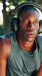 Headphones, fitness and man with breathing in nature for running, workout or training with music. Break, sports and male athlete with audio tech for listening to playlist with cardio exercise outdoor