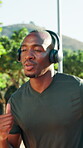 Athlete, man or running with headphones at park for fitness training, endurance challenge or music. Cardio playlist, black person or jog in nature for exercise, sports performance and morning workout