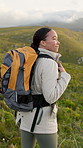 Smile, woman and hiking with backpack on mountain for travel, fitness adventure and sightseeing. Female person, fresh air and trekking to explore nature, backpacking hill and view with green scenery