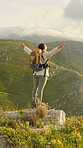 Hiking, winner and mountain with woman outdoor for view, freedom and trekking achievement. Adventure, backpacking goals and success with person and open arms in nature for celebration and target