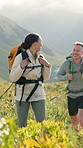 Happy, friends and hiking on mountain for travel adventure, connection and bonding together. People, smile and trekking in nature with backpack for tourist exploration, vacation and wellness journey.