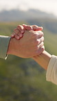 Hiking, help and couple with hands together, closeup and countryside with support. Mountains, man and woman with adventure, journey and trekking with vacation, climbing and traveling with holiday