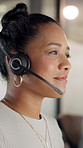Woman, headset and smile at call center in office, reading or typing at night with lead generation. People, consultant and agent with mic, thinking and insight for sales in dark workplace at company