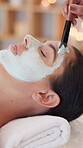 Skincare, hands and woman with face mask at spa for facial treatment, deep cleansing or self care. Relax, client and beauty therapist with clay product application for exfoliation, bokeh and pamper
