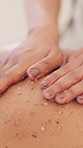 Spa, luxury massage and hands of person with salt scrub for back, skincare and treatment at beauty salon. Cosmetic therapist, body care and detox for relax, zen and exfoliate skin with wellness
