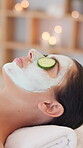 Relax, woman and face mask with cucumber at spa for facial treatment, deep cleansing or self care. Zen, client and peaceful with clay product at wellness clinic for hydration, bokeh and luxury pamper