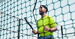 Fist pump, net and padel with man on court for fitness, energy and game competition goal. Success, tennis player achievement and low angle with person outdoor for sports club, contest and target
