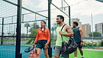 Padel, talking and walking with friends on court together for fitness or training session. Conversation, exercise and sports with group of people outdoor for practice, team building or workout