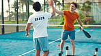 Court, coach and high five with man, padel and celebration for technique development and tournament. Happy, personal trainer and talking to tennis player with racket, achievement and skills for sport