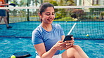 Phone, fitness and woman on tennis court with networking, communication or texting on mobile app. Happy, sports and female athlete on break with cellphone for social media. chatting or contact.