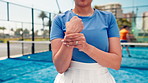 Fitness, padel and woman on tennis court with wrist pain, carpal tunnel or injury for training. Sports, accident and female athlete outdoor with muscle sprain, inflammation or bone fracture at match.