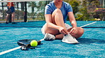 Woman, hands and tying shoes on padel court for outdoor match or workout preparation. Active, female person or legs getting ready with sneakers, tie or laces for sport game, fitness or challenge