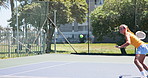Woman, fitness and tennis player with racket for sport match, game or training on outdoor court. Female person, athlete or hitting ball with swing, bat or net for tournament, challenge or exercise