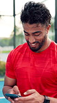 Laugh, padel and phone with man on court for typing, text message or social media post. Digital app, fitness and sports with athlete at outdoor tennis for communication, exercise or mobile update