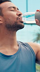 Drinking water, outdoor and man with fitness, wellness and tennis court with hydration. Athlete, liquid and person with aqua, gut health and thirsty with sports, exercise and tired with break or rest