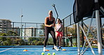 Padel, coach and people on court with cones for practice, exercise and training for competition. Sports, personal trainer and women with equipment for fitness, routine and workout for match or game