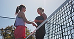 Women, sport and padel tennis with handshake for match, good game or competition on outdoor court. Low angle, female people or friends shaking hands with net for sportsmanship, thank you or finished
