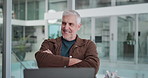 Arms crossed, laptop and smile of business man in office for administration or problem solving. Computer, thinking and typing with mature employee at work for planning, project management or research