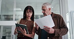 Business people, tablet and documents in office for planning, timesheet verification and HR admin. Mature man, woman and conversation in meeting with tech, paperwork and review for management report.