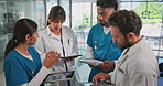 Meeting, teamwork and doctors on tablet in hospital for diagnosis, medical report and feedback. Healthcare, collaboration and people in discussion on digital tech for research, planning and advice