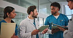 Doctor, tablet and team discussion in hospital for surgery schedule, task delegation or planning. Meeting, nurse or medical group with digital app for clinic management, healthcare update or feedback