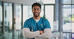 Face, nurse and man with arms crossed for healthcare, wellness and laugh in clinic. Portrait, confident surgeon and medical professional with pride, funny person and about us in hospital in UAE