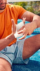 Athlete, man and bandage hand on tennis court from sports injury, fitness mistake and first aid. Male person, gauze and wrap wound from game accident, blister prevention and sprain treatment outdoor