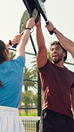 Padel, sports and people with racket outdoor for teamwork, support and motivation for practice on court. Fitness, tennis and men with women high five together for competition, exercise and training
