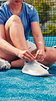 Woman, hands and tie shoes on padel court for outdoor match or workout preparation. Closeup, athlete and training or getting ready with sneakers, laces and sport for game, fitness or challenge