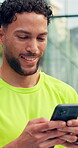 Texting, athlete and man with smartphone, court and communication with contact for training updates. Typing, message and person with mobile for match schedule, connection or tennis player with tech