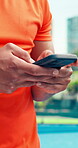 Athlete, online and hands with smartphone, court and communication with contact for training updates. Typing, message and person with mobile for match schedule, connection or tennis player with tech