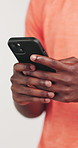 Hands, fitness and man in studio, cellphone or social media with network on white background. Closeup, athlete or healthy person with smartphone, website info or message to contact or online chatting