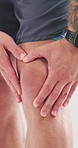 Injury, knee pain and hands of man in studio for workout accident, fitness and training exercise. Sports, person and athlete massage joint for sprain, inflammation and muscle ache on white background