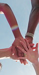 Friends, hands stack and low angle for fitness, outdoor and sky with celebration for training goals. People, men and women in runner group, happy or applause with exercise club for wellness in summer