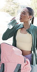 Woman, drinking water and fitness in town with car, electrolytes and hydration for mineral benefits. Person, break and bottle for liquid for wellness, detox or vehicle for exercise routine in city