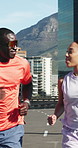 Running, fitness and couple in city, support and training with marathon, exercise and discussion. Happy people, runners and athlete in street, wellness and endurance with practice, cardio and workout