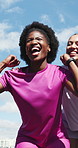 Fitness team, excited woman and celebration for success, victory achievement and low angle outdoor. Exercise, happy group and cheering for marathon winner, goal accomplishment or champion fist pump
