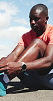 Athlete, black man and tying shoes on road for getting ready, fitness preparation and exercise. Male person, lace and footwear for sports training, runner safety and practice for endurance challenge