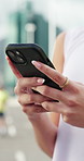 Hands, phone and texting in street with fitness, check stats or search for running route with training. Person, smartphone and click on mobile app, review and steps for exercise routine in urban city