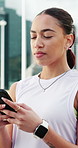 Woman, phone and texting in city with fitness, check stats or search for running route with training. Person, smartphone and click on mobile app, review and steps for exercise routine in urban town