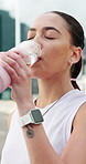 Fitness, woman and drinking water in city with bottle for sports hydration, workout and exercise break. Active, female person outdoor and wellness with beverage for thirst, electrolytes and recovery.