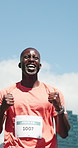 Celebration, running and black man with race finish line for workout, training or competition. Fitness, clapping hands and African male athlete cheering with cardio exercise at sports marathon.