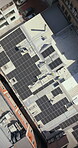 Drone, architect and people on building, solar panels and property development with renewable energy. Outdoor, architecture and colleagues with sustainable power, aerial view and civil engineering