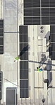 Drone, architecture and people on rooftop, solar panels or property development with sustainability. Outdoor, group and colleagues with renewable energy, aerial view and civil engineering in city