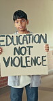 Education, poster and face of child in school, anti violence protest or movement for safe learning. Activism sign, serious or boy with message for positive change, awareness or call for academy peace